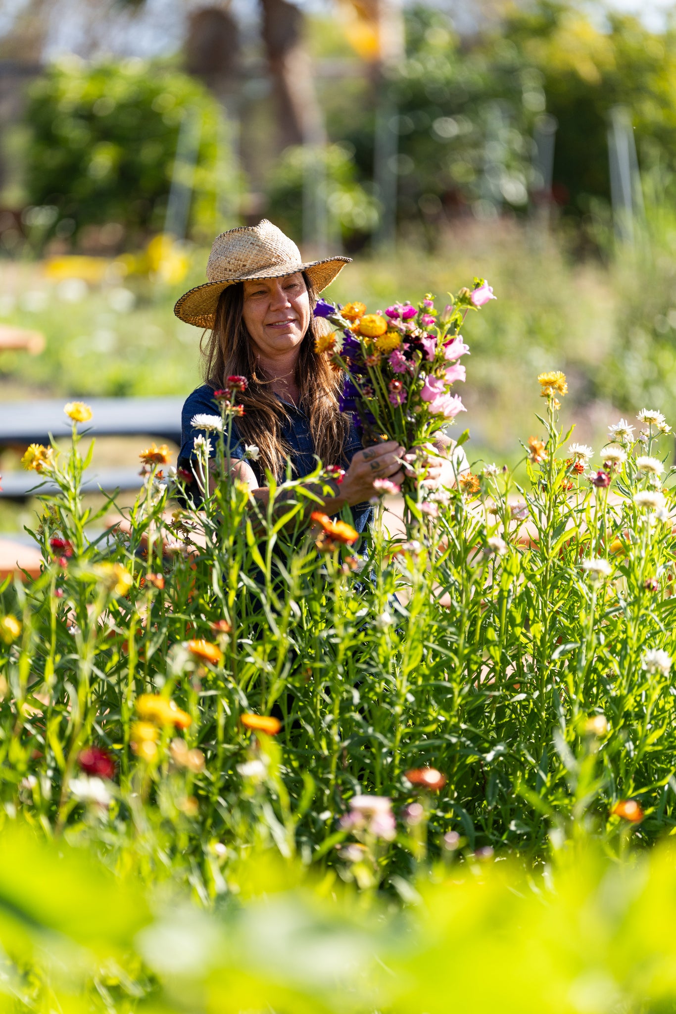Woman in a garden holding a bouquet of flowers